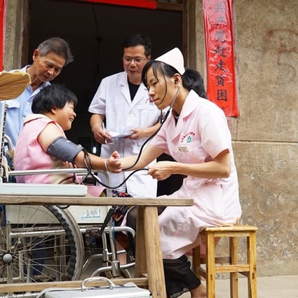 Liao Binsheng and his family receive a physical condition examination at home in Yushui District of Xinyu City, east China's Jiangxi Province, June 12, 2018. While only 7.7 per cent of China’s hospitals are rated “triple-A”, they handled half of all outpatient visits in 2016. Photo: Xinhua
