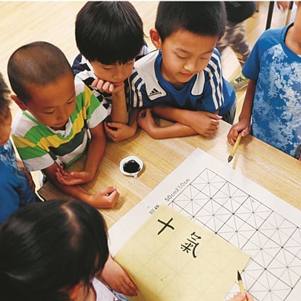 Students practise traditional Chinese calligraphy at Ririxin School in Beijing’s Changping district, which offers an alternative to traditional education. Photo: Simon Song