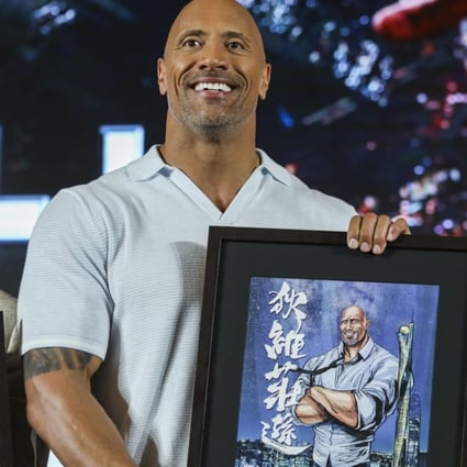 Skyscraper stars Chin Han, Dwayne Johnson and Neve Campbell with sketches of themselves presented to cast members at their appearance in Hong Kong ahead of the film’s opening in the city next week. Photo: Sam Tsang