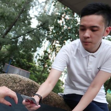 Horoscope and card reader Alanstair Lau Siu-yu, 26, in Tsuen Wan West. Photo: Jonathan Wong