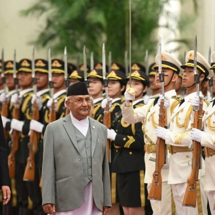 Nepalese Prime Minister K P Sharma Oli (centre) and Chinese Premier Li Keqiang review a military guard of honour during a welcome ceremony at the Great Hall of the People in Beijing on June 21. Nepal and China signed eight agreements during the visit. Photo: AFP