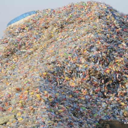 A worker inspects plastic for recycling at a factory in Wuhan, in Hubei province, China in 2010. Picture: Alamy