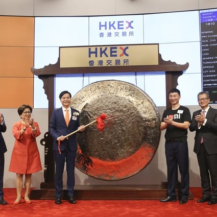 Xiaomi founder, chairman and CEO Lei Jun hits the gong during the listing of the company in Hong Kong on Monday. Photo: Sam Tsang