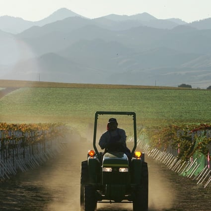A farm worker drives a tractor through the a vineyard during harvest at the Byron Vineyard and Winery in Santa Maria, California, in 2006. Vineyards, nut farms, microchip production plants and car engine factories will be seriously impacted if the trade war between the United States and China deepens. Photo: AFP
