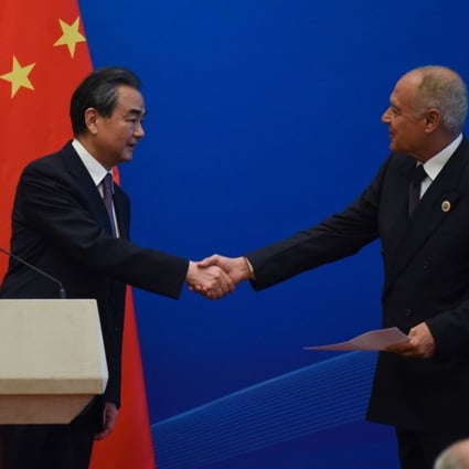 Chinese Foreign Minister Wang Yi and Arab League Secretary-General Ahmed About Gheit shake hands at the end of a joint news conference during the eighth Ministerial Meeting of the China-Arab States Cooperation Forum in Beijing on Tuesday. 2018. Photo: AFP
