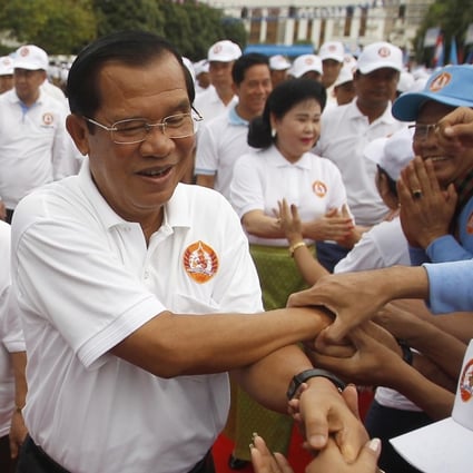 Cambodian Prime Minister Hun Sen greets supporters at a campaign rally on July 7. His Cambodian People’s Party is expected to sweep the polls after the government dissolved the main opposition party. The Cambodian strongman is at the peak of a reign that began in 1985. Photo: AP