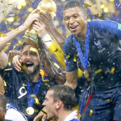 Olivier Giroud, alongside Kylian Mbappe, raises the trophy after France beat Croatia 4-2 to win the country’s second World Cup at Luzhniki Stadium in Moscow. Photo: Kyodo