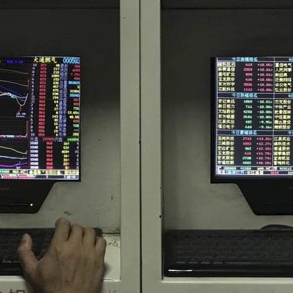 A man monitors stock prices at a brokerage house in Beijing. Photo: AP