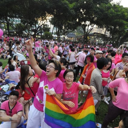 Two women cheer at a Pink Dot rally in support of gay rights in Singapore. Photo: AP