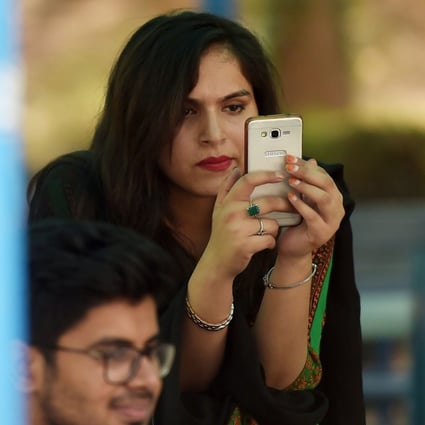 A student uses her mobile phone at a campus in Islamabad. Photo: AFP