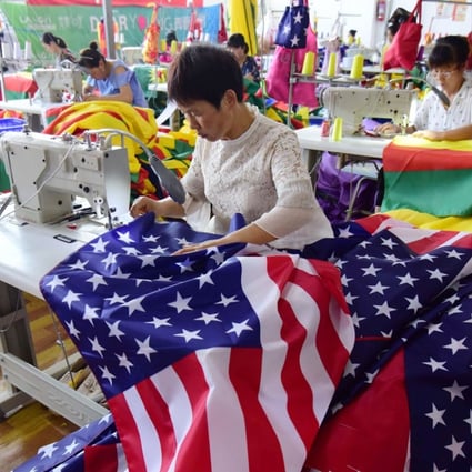 This July 13, 2018 photo shows Chinese employees sewing US flags in Fuyang in Anhui province. As the Sino-US trade war rages, a factory set amid corn and mulberry fields in central China stitches together US and "Trump 2020" flags -- and business is good. Photo: AFP