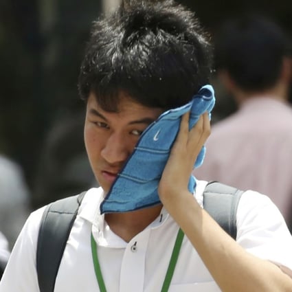 A man wipes the sweat from his face in the scorching heat in Tokyo. Photo: AP