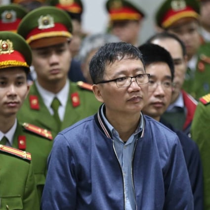 Trinh Xuan Thanh (centre), a former oil executive, stands trial at the courtroom of Hanoi People's Court on January 8. Photo: Agence France-Presse