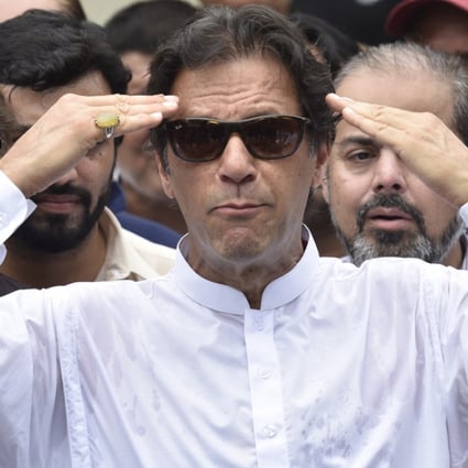 Imran Khan, head of Pakistan Tehrik-e-Insaf (PTI) speaks to journalists after casting his ballot at a polling station during general elections in Islamabad on Wednesday. Photo: EPA