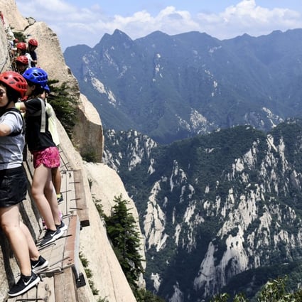 Visitors make their way along the narrow path on Huashan’s southern peak. Photo: Xinhua