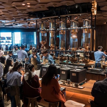 Visitors wait for their coffee at the Starbucks Reserve Roastery store in Shanghai on December 6, 2017. Starbucks opened its largest cafe in the world in Shanghai on December 6 as the US-based company bets big on the burgeoning coffee culture of a country traditionally known for tea drinking. Photo: Agence France-Presse