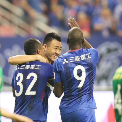 Shanghai Shenhua players celebrate after scoring against Beijing Guoan during the China derby. Photo: Xinhua