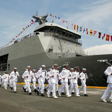 Members of the Philippine navy run past a warship during a 2016 ceremony. Photo: Reuters