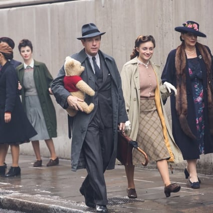 Christopher Robin (Ewan McGregor) walks down a London street with his childhood companion Winnie the Pooh in the Disney movie Christopher Robin (category I), directed by Marc Forster. Hayley Atwell and Bronte Carmichael co-star.