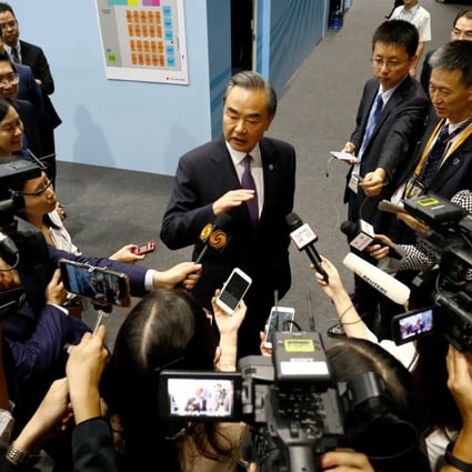 China’s Foreign Minister Wang Yi speaks to reporters after meetings on the sidelines of the Asean Foreign Ministers’ Meeting in Singapore on Friday. Photo: Reuters