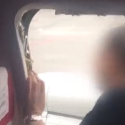 Passengers filmed the man as he opened the escape hatch. Photo: Weibo