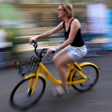 A woman rides an Ofo bike in Paris. Photo: Reuters