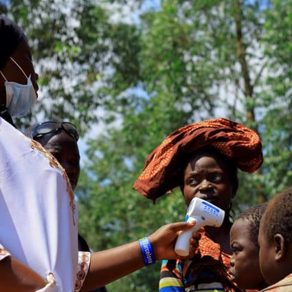 A Congolese health worker checks the temperature of a child before the launch of vaccination campaign against the deadly Ebola virus near Mangina village, near the town of Beni, in North Kivu province of the Democratic Republic of Congo on Wednesday. Photo: Reuters