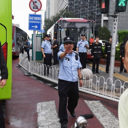 Police stand in front of the China Banking Regulatory Commission last Monday. Hundreds of police swarmed the streets of Beijing’s financial district on August 6 as a planned protest over P2P lending was quashed. Photo: AFP