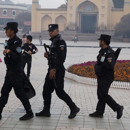 Uygur security personnel patrol near the Id Kah Mosque in Kashgar in Xinjiang region. Photo: AP