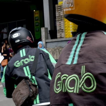 GrabBike riders wait for passengers outside a commuter railway station in Jakarta on June 13, 2018. Photo: Agence France-Presse