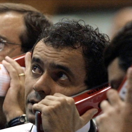 Traders on the phone on 20 June 2002 at the Sao Paulo Stock Exchange (Bovespa) in Sao Paulo, Brazil. Rating agency Moody's Investors Service said 20 June 2002 it had cut its outlook for Brazil's foreign currency credit ratings to "negative" from "stable" because of deteriorating investor sentiment. Investors' confidence has been undermined by "perceived uncertainties associated with the outcome of the October election," the agency said, "despite the present government's maintenance of a sound macroeconomic policy mix." Photo AFP