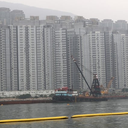 Reclamation work in Tung Chung. The yellow floats form a net preventing sand and rocks from spreading, though enviromental groups doubt its reliability. Photo: Nora Tam