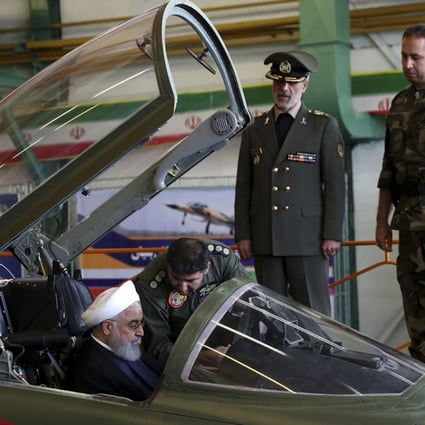 Iranian President Hassan Rowhani sitting in the cockpit of the fighter jet before the inauguration ceremony. Photo: AP