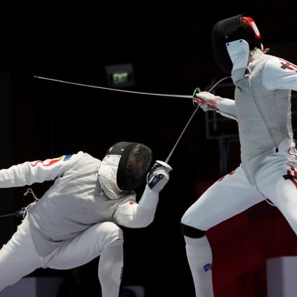 Huang Mengkai of China in action with Nicholas Choi of Hong Kong in the final of the men’s foil. Photo: Reuters