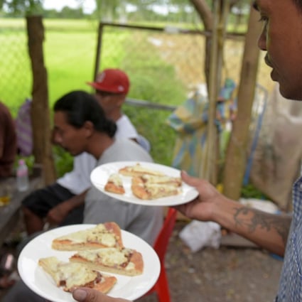 A little slice of America is served to refugees who were deported to Cambodia from the United States. Photo: AFP