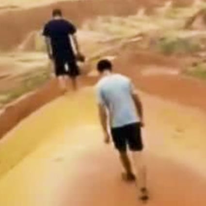 Two of the young Chinese tourists who broke into a Danxia national geopark in Zhangye, Gansu province and filmed themselves damaging the ancient landform. Photo: Weibo