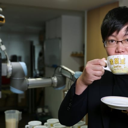 Karen Wong, vice-president of the Association of Coffee and Tea of Hong Kong, tasting a cup of milk tea made by robot KamChAI. Photo: Xiaomei Chen