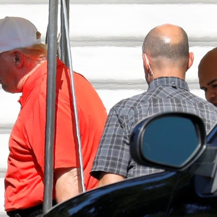 US President Donald Trump getting in his limo before changing his mind and returning to the White House to watch television on Monday. Photo: Reuters