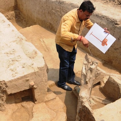 An archaeologist looks at the remains of a chariot belonging to the Indus Valley civilisation at an excavation site in Baghpat. Photo: AFP