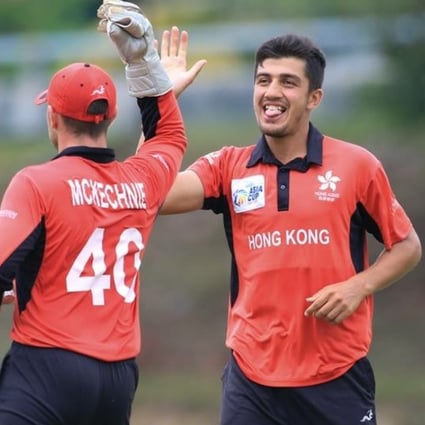 Scott McKechnie and Aizaz Khan celebrate one of the latter's five wickets. Photo: ACC