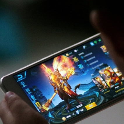 A child plays the game Honour of Kings by Tencent at home in China. Photo: Reuters