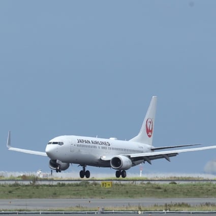 A passenger aircraft operated by Japan Airlines lands at Kansai International Airport. Photo: Bloomberg
