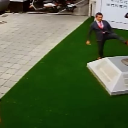 Mitsuhiko Fujii, representing 16 right-wing groups from Japan, is seen kicking the bronze statue outside the Kuomintang’s office in Tainan on Thursday. Photo: Facebook
