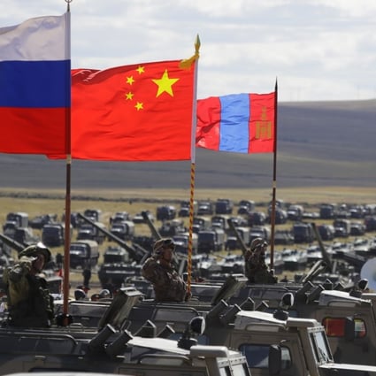 Russian, Chinese and Mongolian national flags fly from armoured vehicles during joint military exercises on Thursday in eastern Siberia. Photo: AP