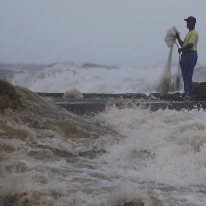 A Filipino fisherman near the shoreline in the town of Aparri, Cagayan province, which was set to take a battering from Mangkhut. Photo: EPA