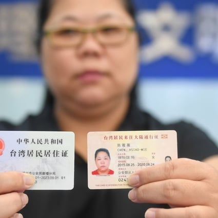 A Taiwanese woman shows off her new mainland residence permit (left). Photo: Xinhua