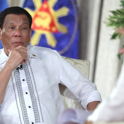 Philippine President Rodrigo Duterte listening to a question from chief presidential legal counsel Salvador Panelo during a state television talk show at Malacanang palace in Manila on Tuesday September 11, 2018. Photo: AP