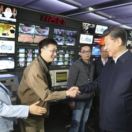 Chinese President Xi Jinping (right) shakes hands with staff members at China Central Television (CCTV) in Beijing. The US Department of Justice has ordered CGTN, CCTV’s international arm, to register with the government as a foreign agent. Photo: AP