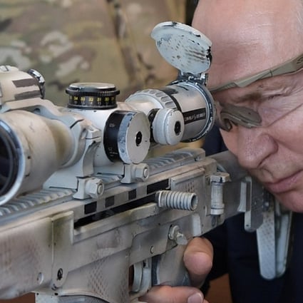 Russian President Vladimir Putin aims a Chukavin sniper rifle at a firing range outside Moscow, on Wednesday. Photo: Reuters