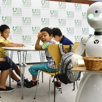 A cafe will open in Tokyo’s Akasaka district in November featuring robot waiters remotely controlled from home by people with severe physical disabilities. Photo: Kyodo